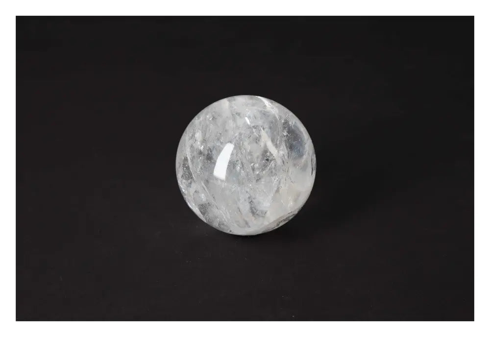 Elegant Lemurian Quartz Sphere by Sylvia Crystals on a black background, showcasing its premium luxury and spiritual allure.
