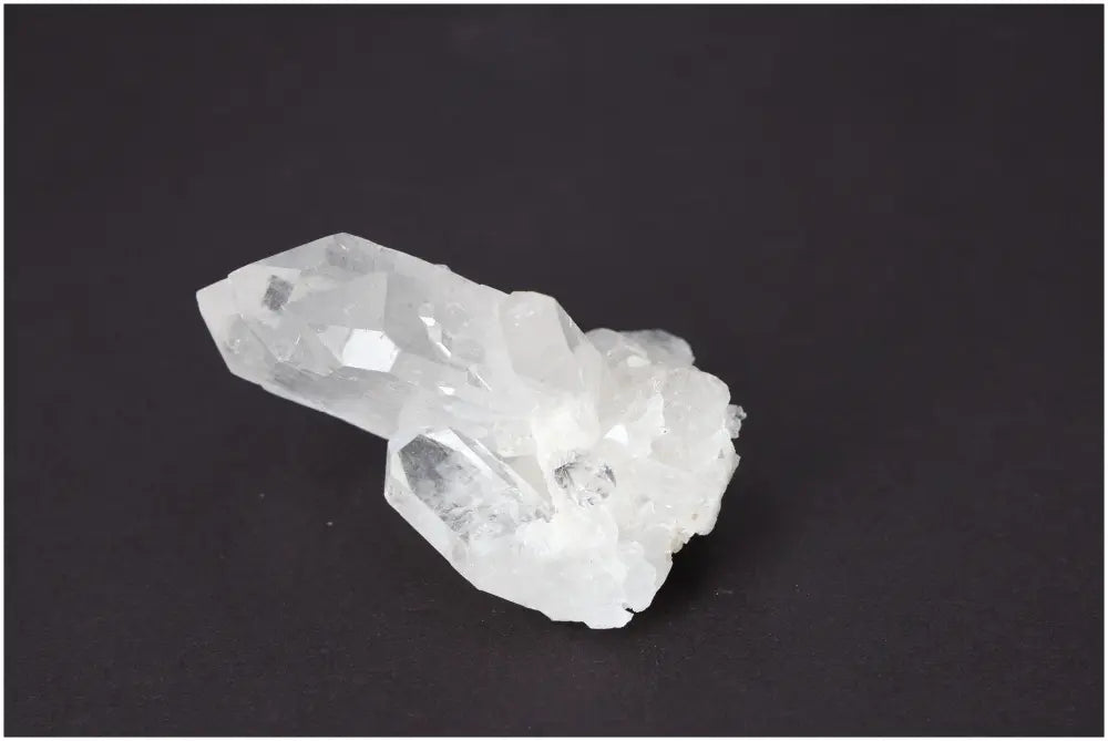 Rough crystal quartz cluster on dark background showcasing natural beauty and metaphysical power.