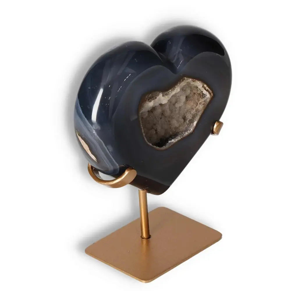 Luxurious agate heart crystal on a stand, showcasing unique textures and harmonizing energy properties, by Sylvia Crystals.