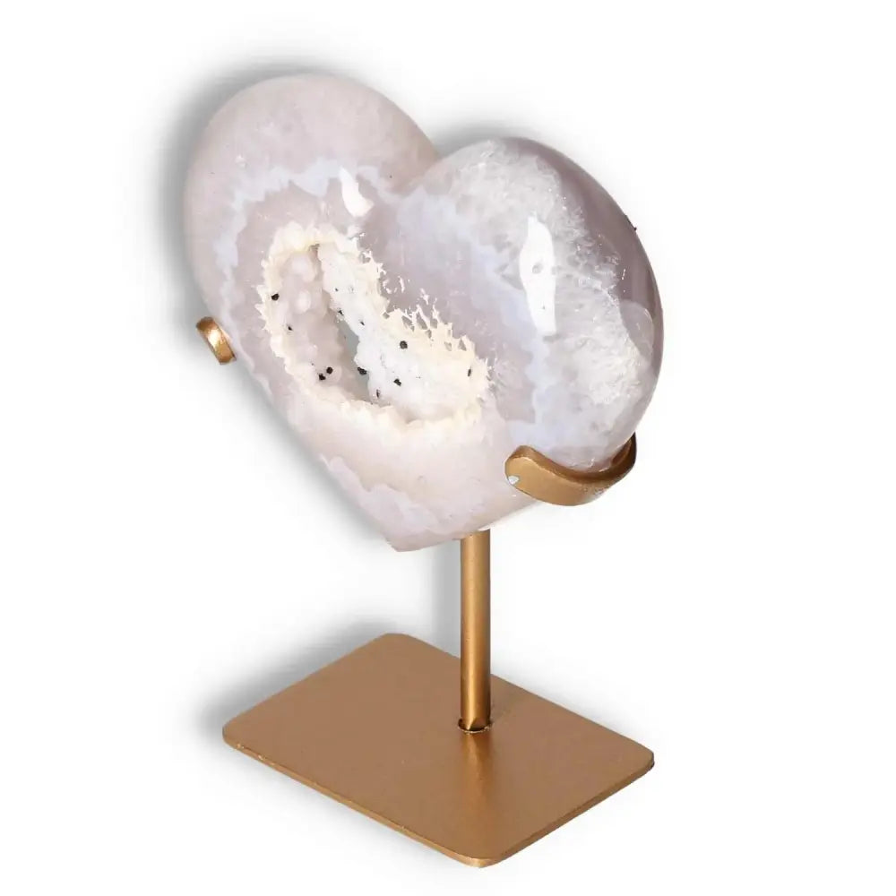Luxurious Agate Heart by Sylvia Crystals, showcasing unique energy harmonizing properties for body and mind balance on elegant stand.