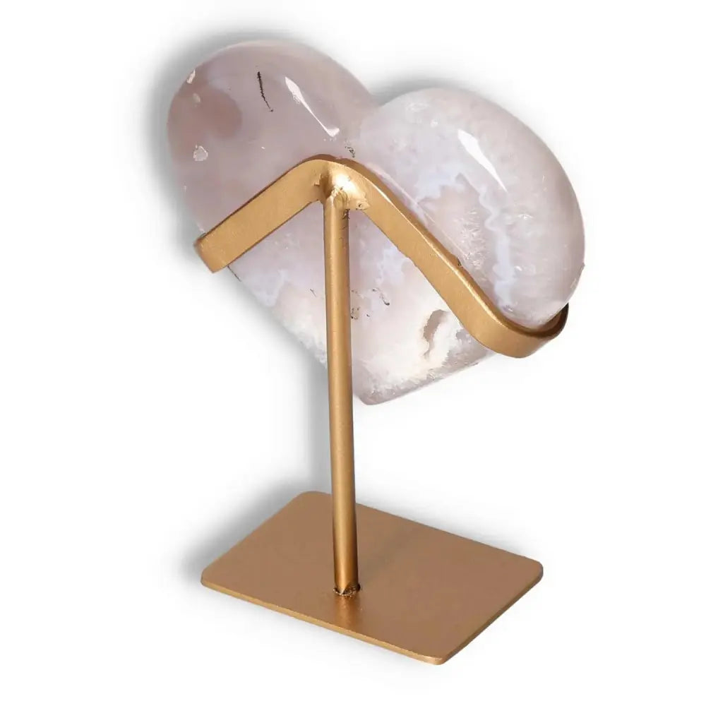 Agate Heart by Sylvia Crystals on gold stand, known for energy harmonizing and balancing properties, elegant home decor piece