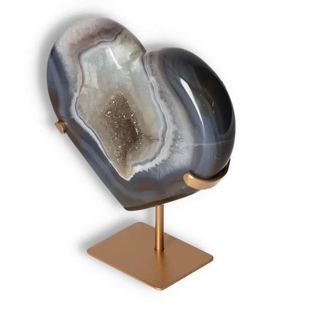Elegant agate heart sculpture with unique patterns and stand, showcasing natural veining and crystalline formations.