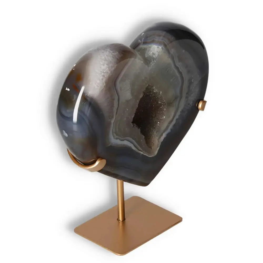 Agate heart sculpture on a stand showcasing unique patterns and natural veining, perfect for adding elegance and symbolic beauty to any space.