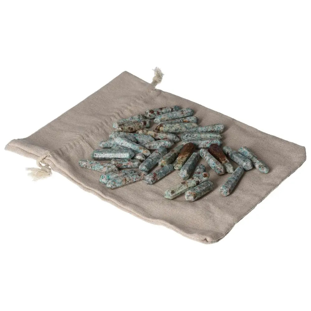 Amazonite small sticks on a beige cloth, promoting harmony and emotional balance with a calming effect