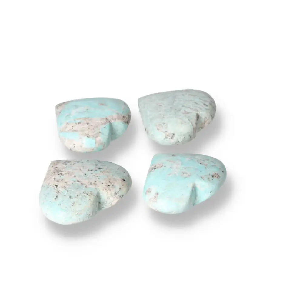 Four heart-shaped Amazonite stones showcasing soothing turquoise and green shades, symbolizing courage and emotional balance.