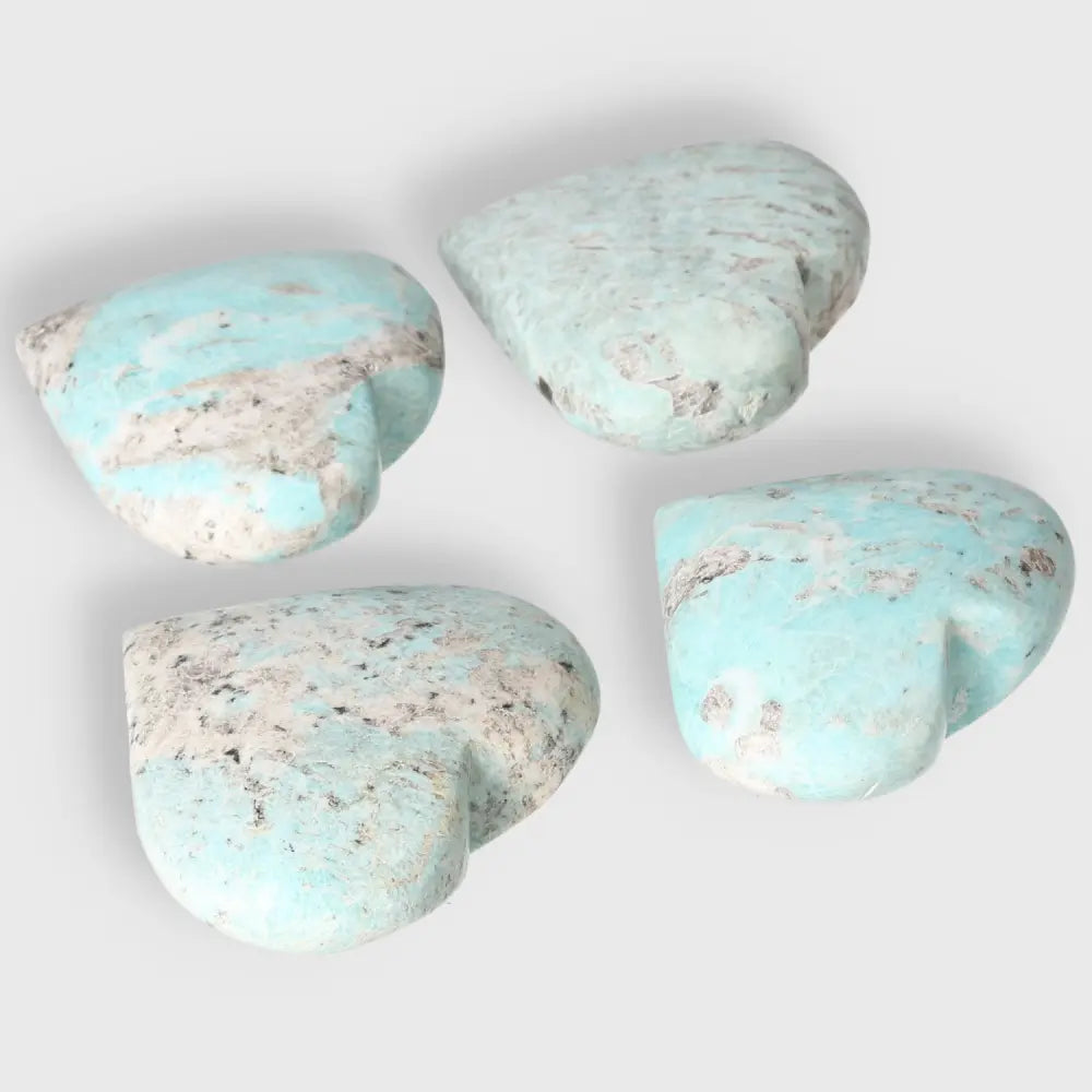 Amazonite heart-shaped stones in calming turquoise and green hues showcasing natural patterns and textures.