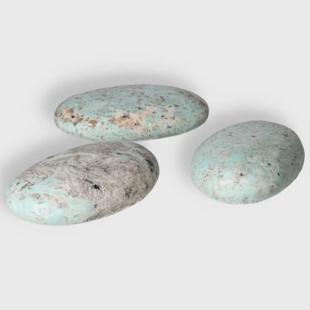Amazonite palm stones with calming turquoise and green shades, promoting balance and clarity.