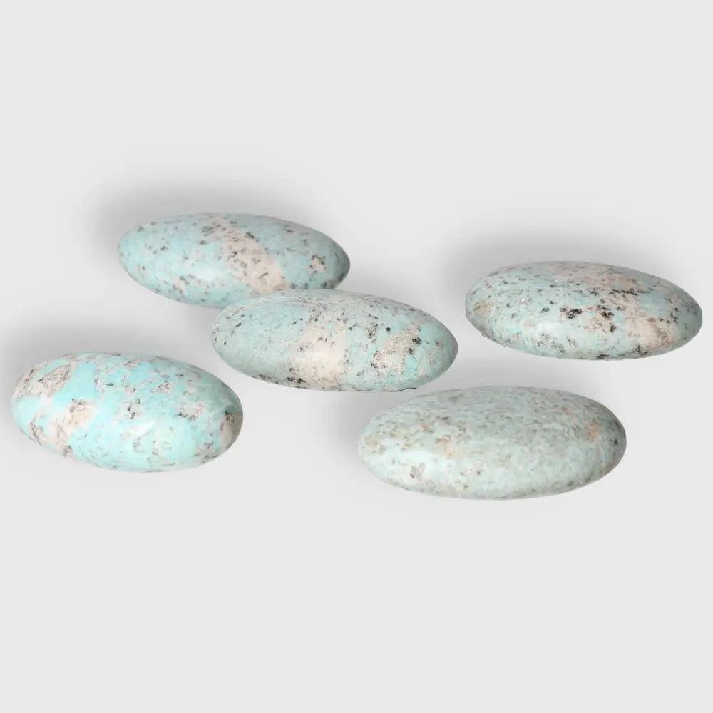Amazonite palm stones with soothing turquoise and green hues, promoting emotional balance and inner connection.