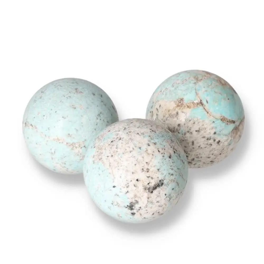 Amazonite spheres in calming turquoise and green, known as the "Stone of Courage and Truth" promoting emotional balance and clarity.