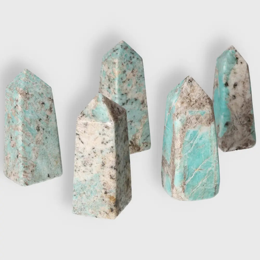 Five Amazonite towers showcasing unique turquoise and green patterns, promoting emotional balance and deepening inner connection.