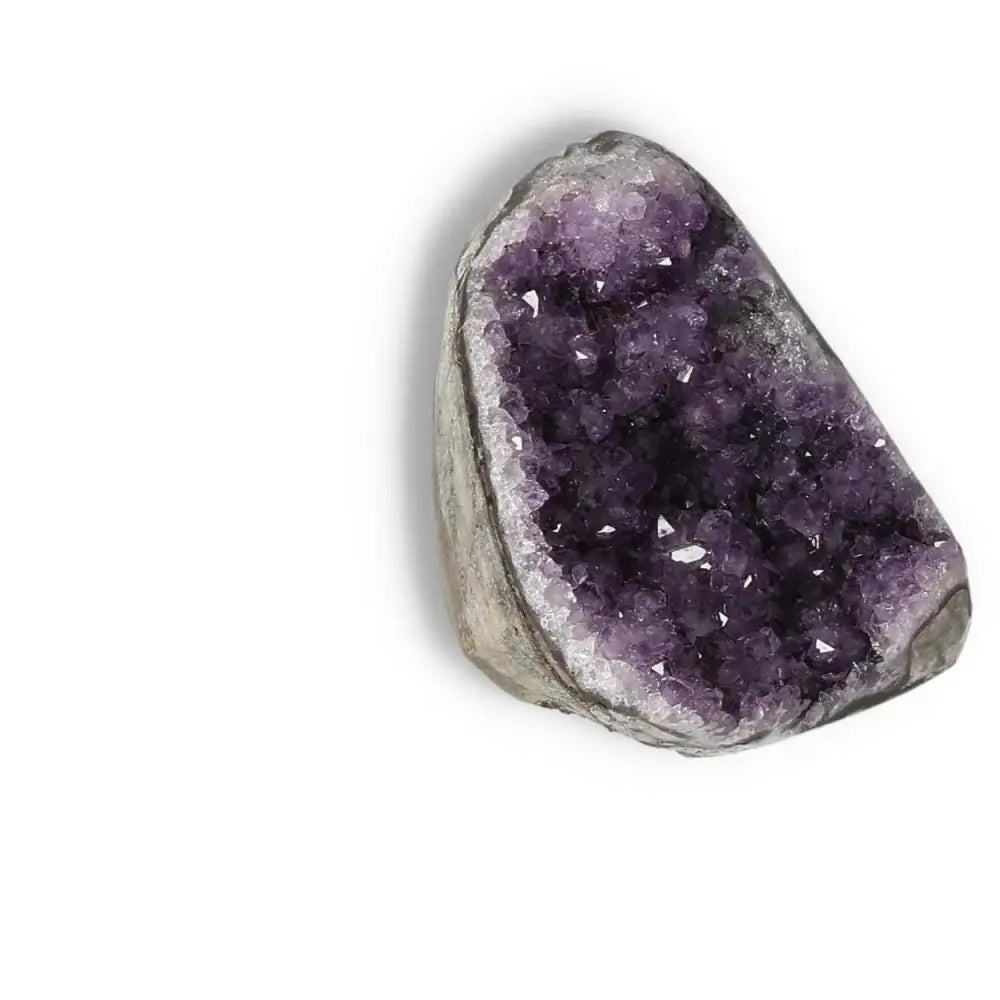 Amethyst cut base geode from Sylvia Crystals showcasing deep purple hues and crystal formations for stress relief and energy enhancement.