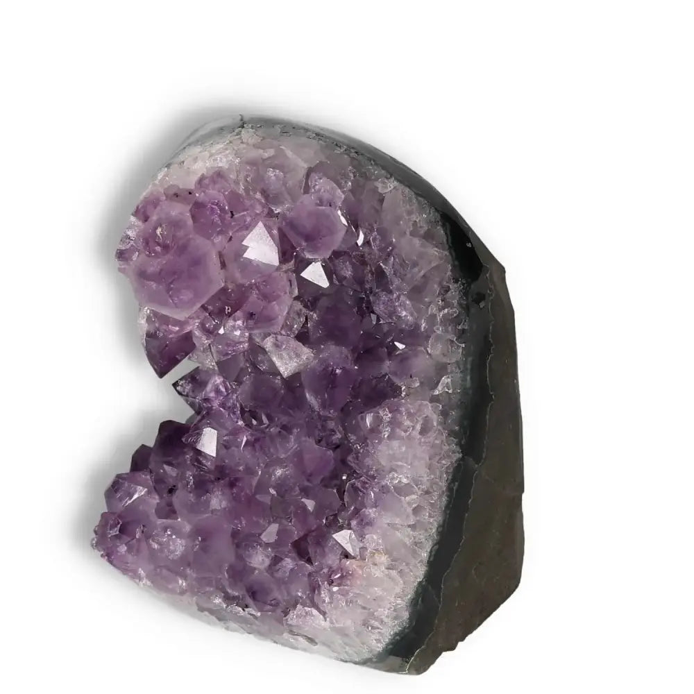 Amethyst Cut Base Geode with deep purple crystals, from Sylvia Crystals, ideal for emotional stability and concentration enhancement.