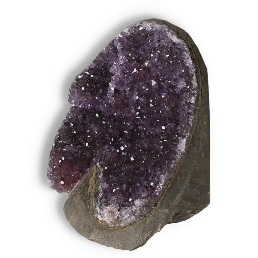 Amethyst Cut Base Geode with shimmering crystals, part of the Sylvia Crystals collection, known for stress relief and concentration enhancement.