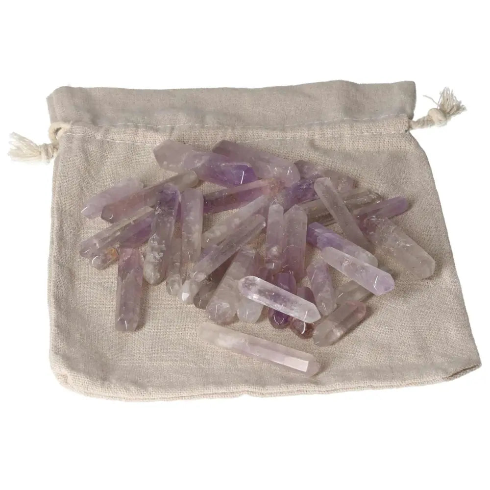 Amethyst Small Stics on a cloth bag, known for stress reduction, energy boost, concentration enhancement, and emotional stability.