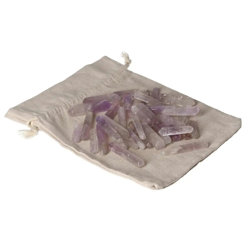 Amethyst small sticks on a canvas pouch for stress reduction, energy boost, and emotional stability enhancement.