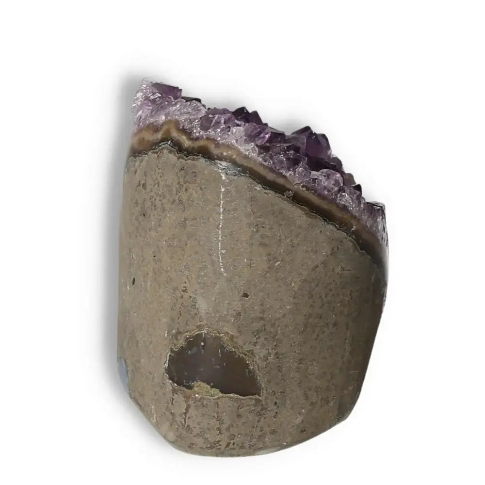 Elegant Amethyst cut base geode showcasing its unique purple crystals from Sylvia Crystals, known for tranquility and stress relief.