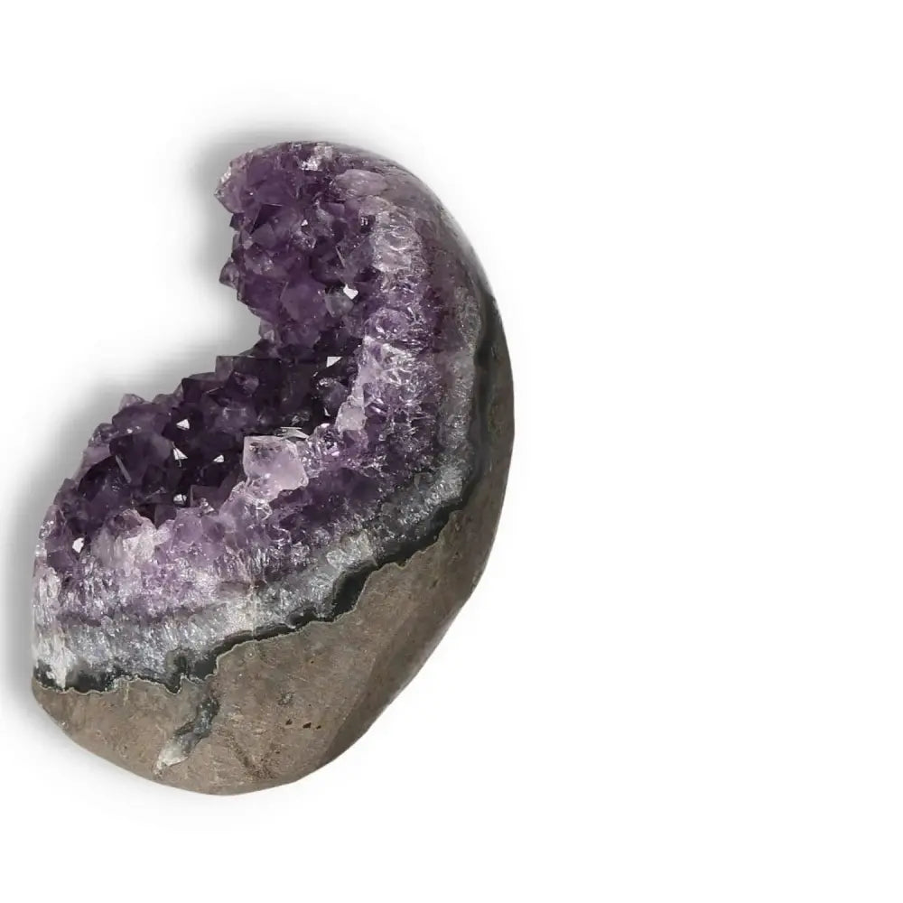 Amethyst cut base geode with deep purple crystals by Sylvia Crystals, known for stress reduction and enhanced concentration.