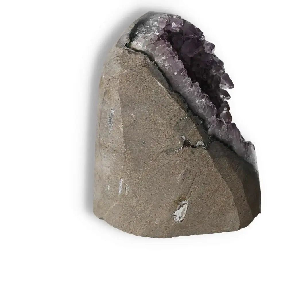 Amethyst cut base geode from Sylvia Crystals, blending luxury with spiritual wellness, known for stress relief and focus enhancement.
