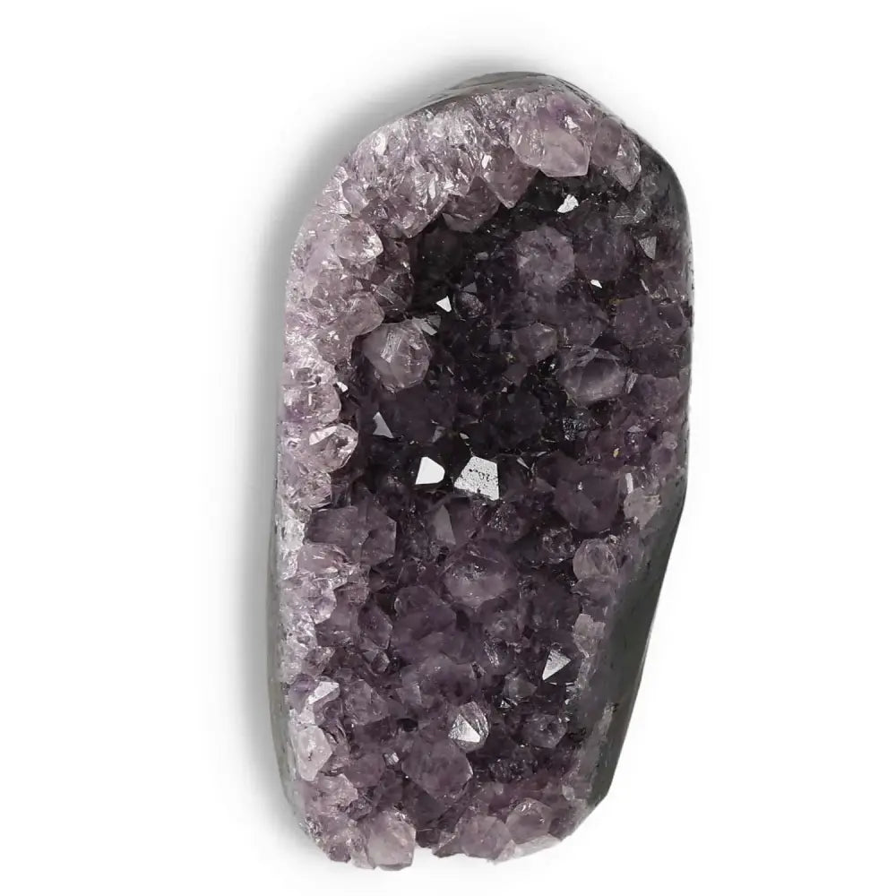 Amethyst cut base geode from Sylvia Crystals, enhances emotional stability, stress relief, and concentration with purple crystal clusters.