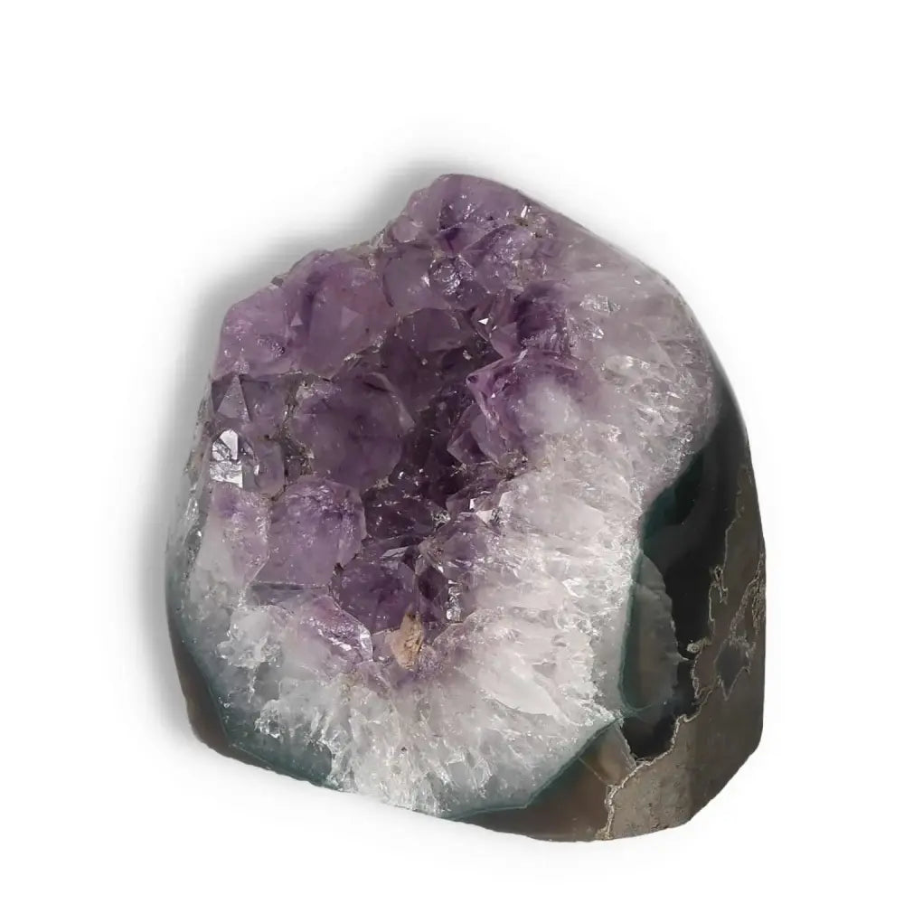 Amethyst cut base geode from Sylvia Crystals, showcasing violet crystals and natural beauty for stress reduction and energy enhancement.