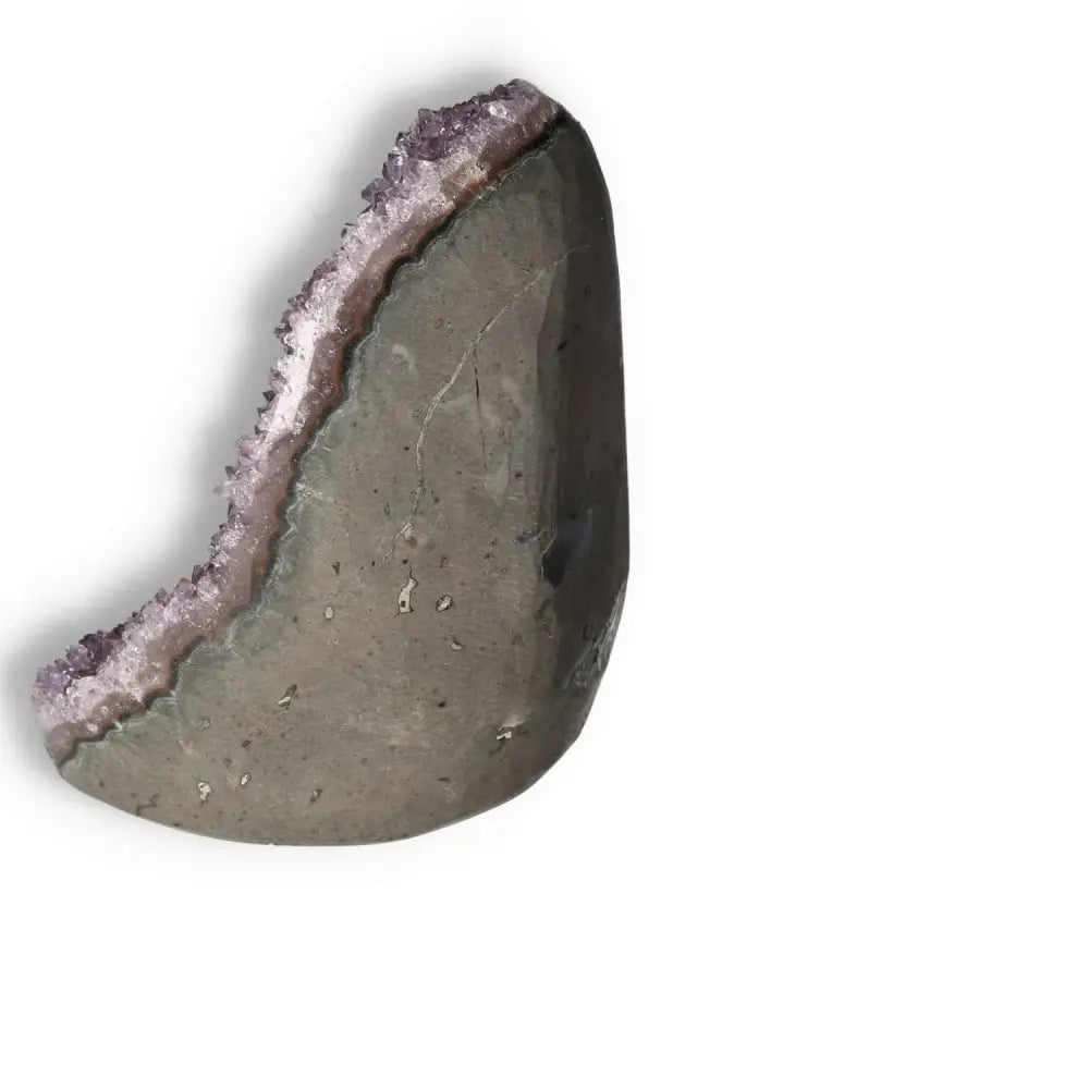 Amethyst cut base geode by Sylvia Crystals, showcasing luxury and spiritual harmony as a stunning centerpiece.