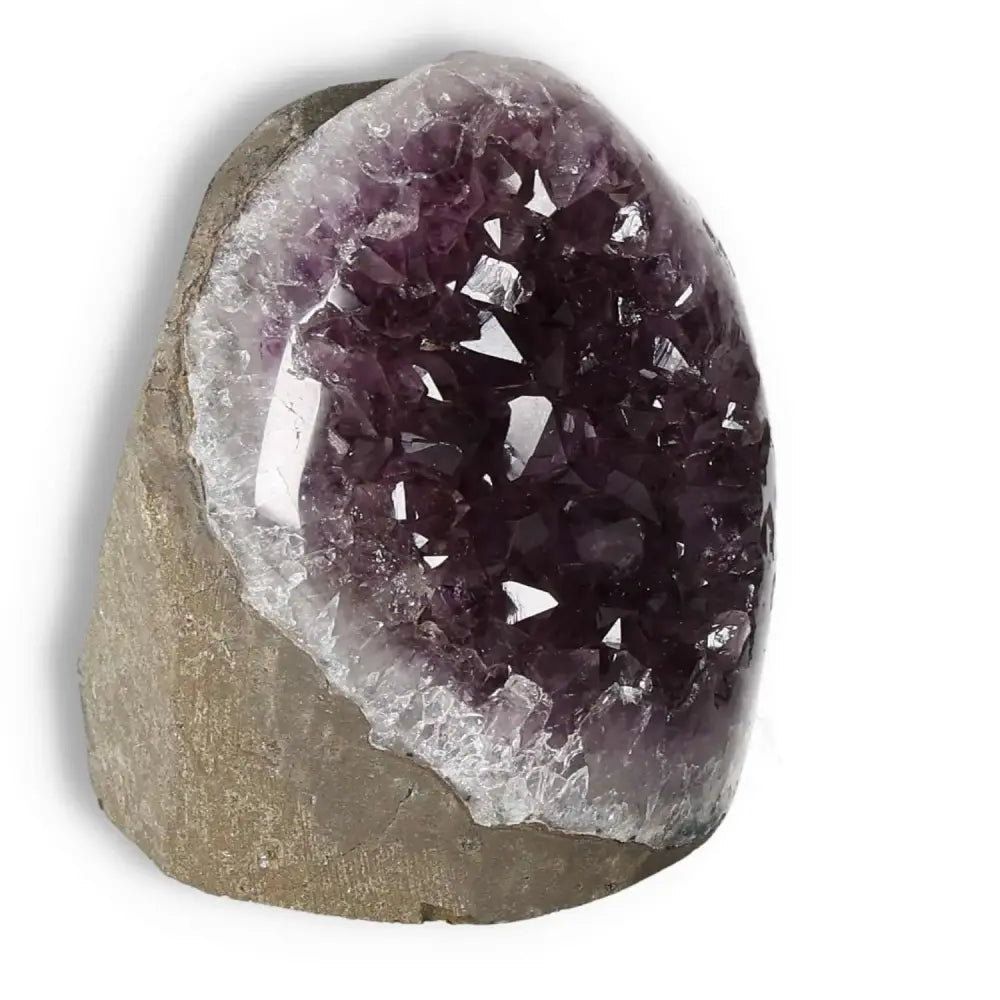 Amethyst cut base geode by Sylvia Crystals, enhances concentration, emotional stability, and reduces stress with its enchanting allure.