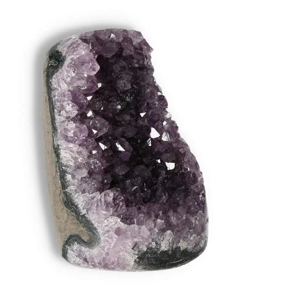 Amethyst cut base geode by Sylvia Crystals, a handpicked gem rich in transformative energy, displayed at an angle.