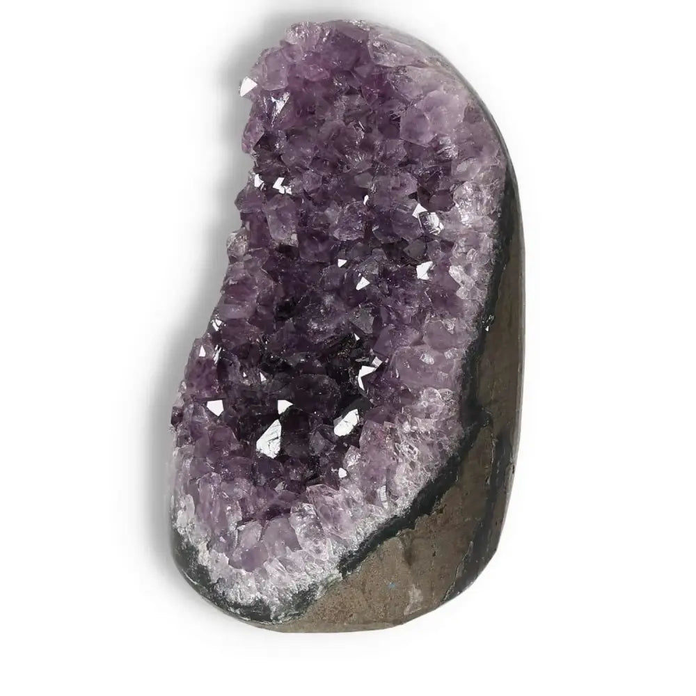 Amethyst cut base geode from Sylvia Crystals, showcasing deep purple hues and a rough exterior, ideal for stress relief and energy boosting.