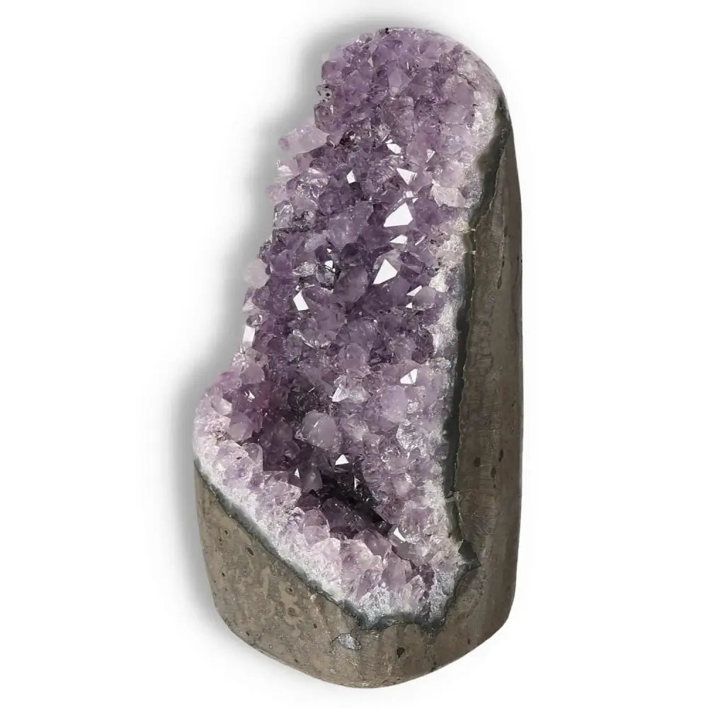 Amethyst cut base geode from Sylvia Crystals showcasing purple crystal formations, known for stress reduction and energy boost.