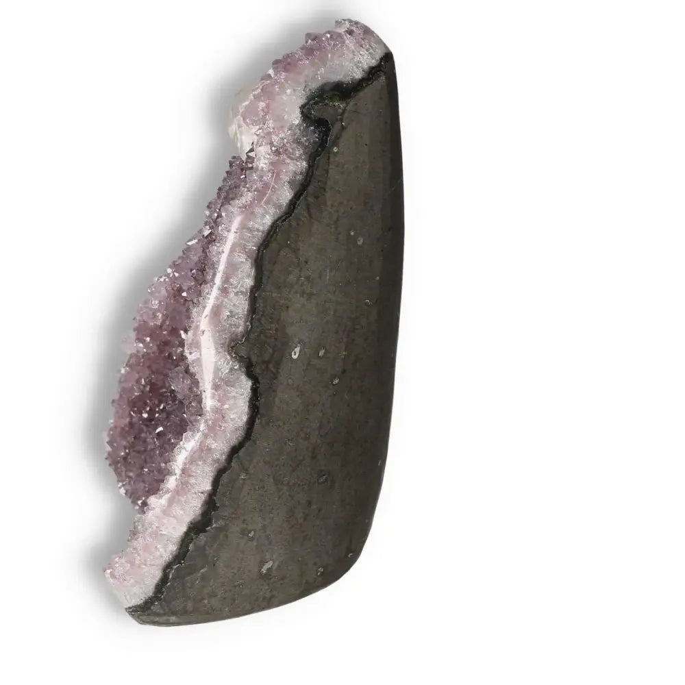 Amethyst and Calcite Cut Base Geode from Sylvia Crystals, known for calming and enhancing mindfulness, with a natural edge display.