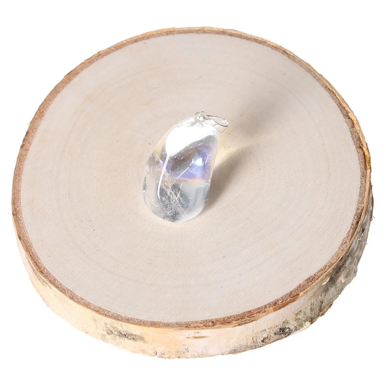 Angel Aura Tumbled Pendant resting on a wooden slice, showcasing its luminescent sheen and iridescent hues.