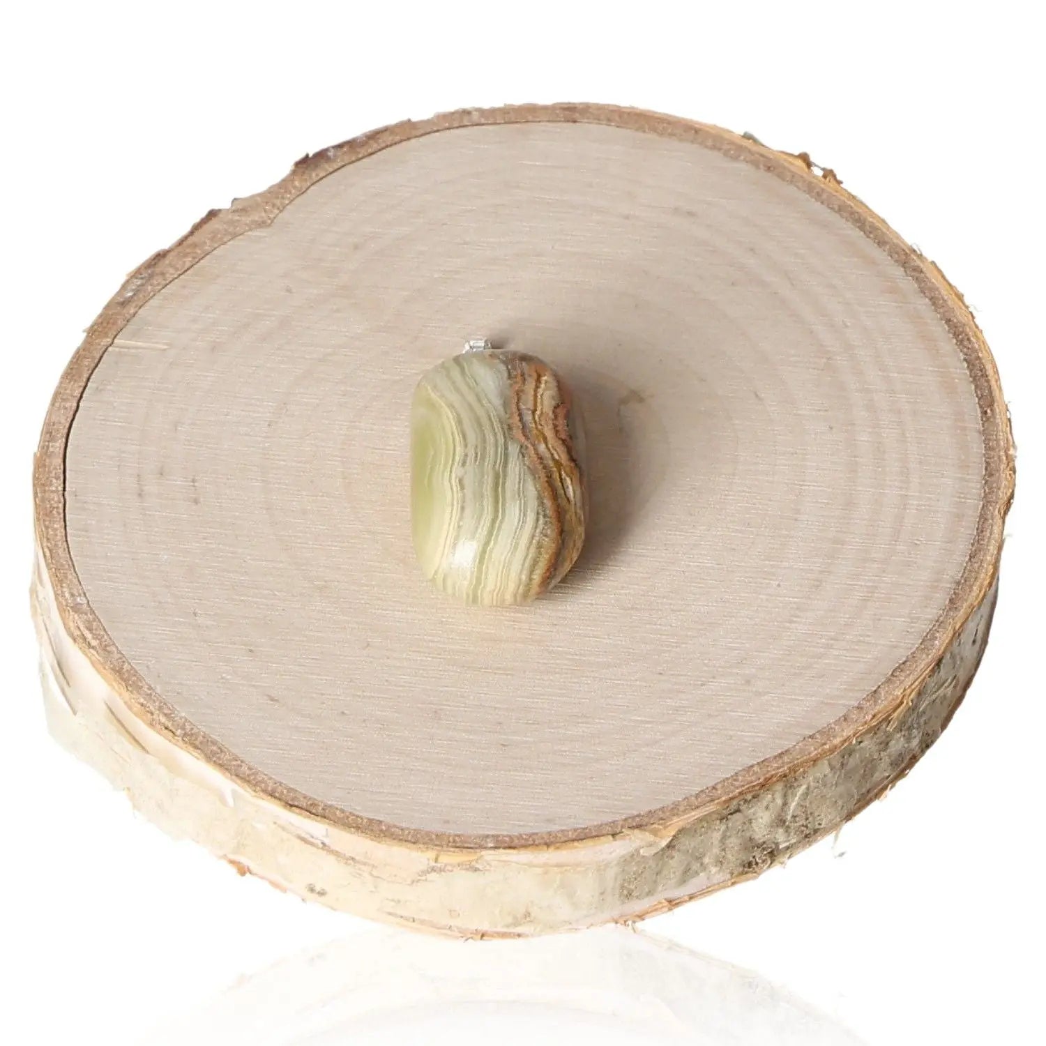 Aragonite tumbled pendant displayed on a wooden slice, showcasing its natural striped patterns and earthy tones for grounding energy.