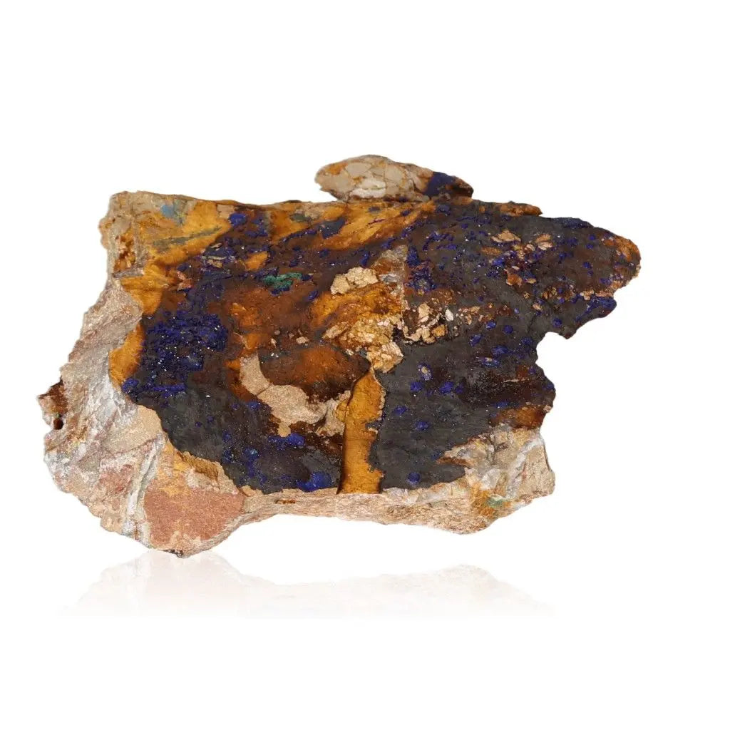 Azurite druzy stone with deep blue hues and vibrant color, enhancing intuition and spiritual insight, on a reflective white background.