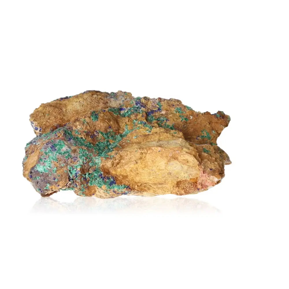 Azurite druzy with vibrant blue hues and rough texture, known for enhancing intuition and spiritual insight, displayed on a reflective surface.