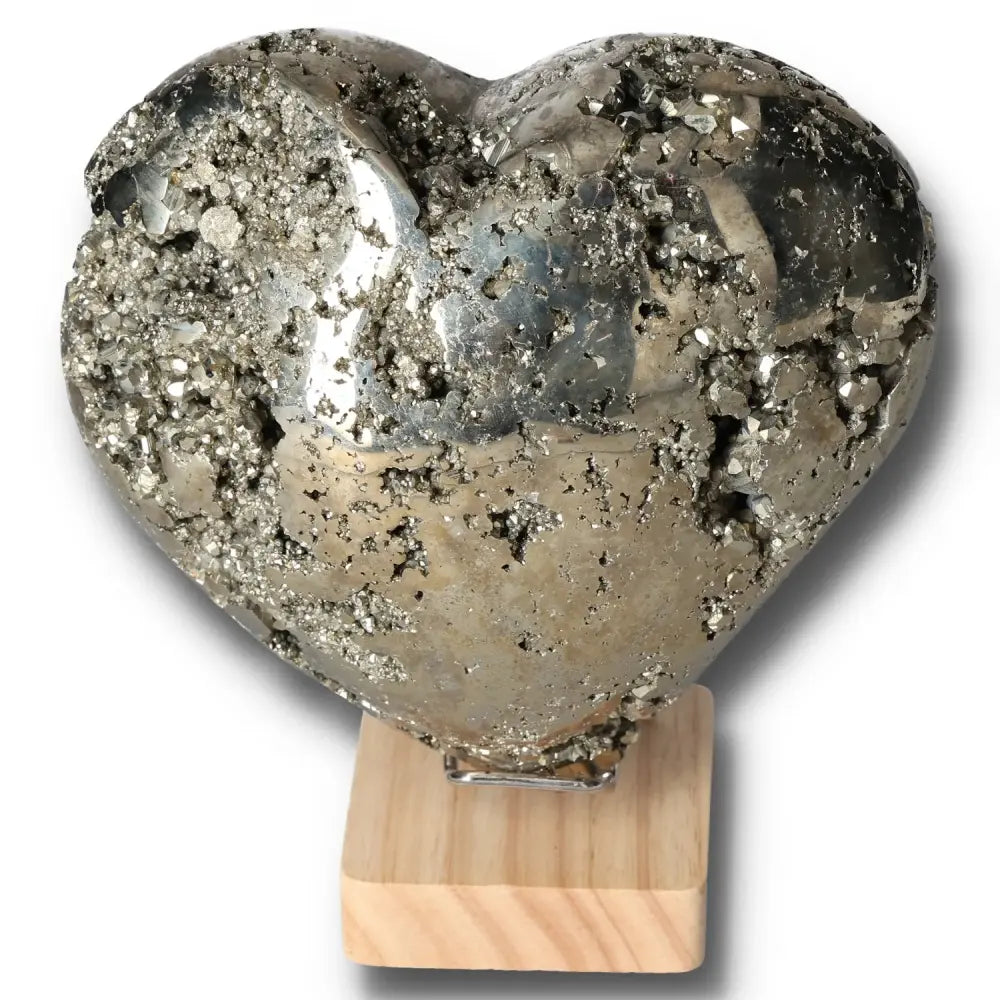 Heart-shaped pyrite stone on stand, promotes independence and courage, ideal for motivation and goal achievement.