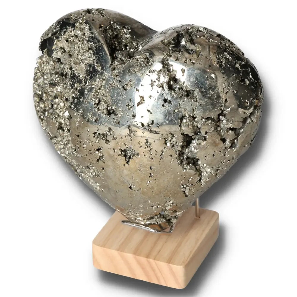 Heart-shaped pyrite stone on wood base, symbolizing courage, independence, and idea generation. Ideal for motivational decor.