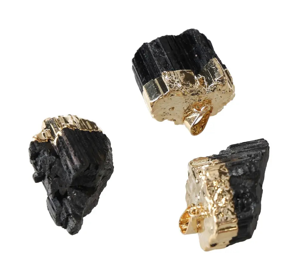 Three black tourmaline pendants with gold accents displayed against a white background.