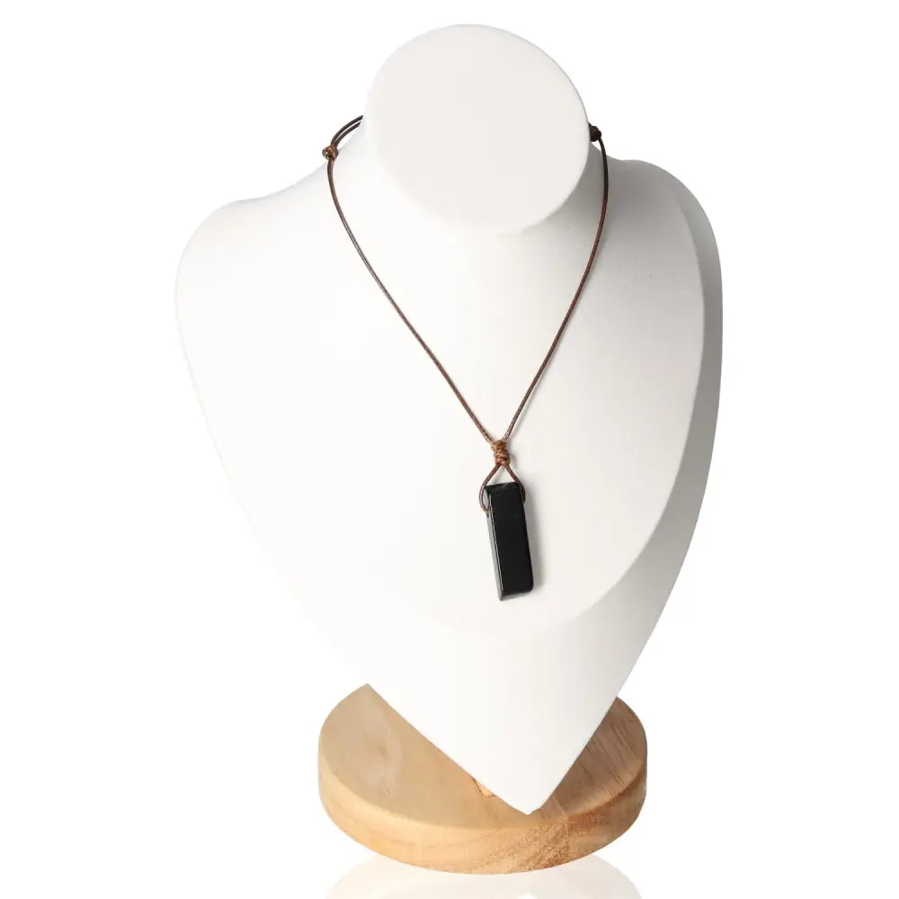 Elegant boho necklace with obsidian pendant on display stand, offering style and spiritual protection, perfect for bohemian fashion lovers.