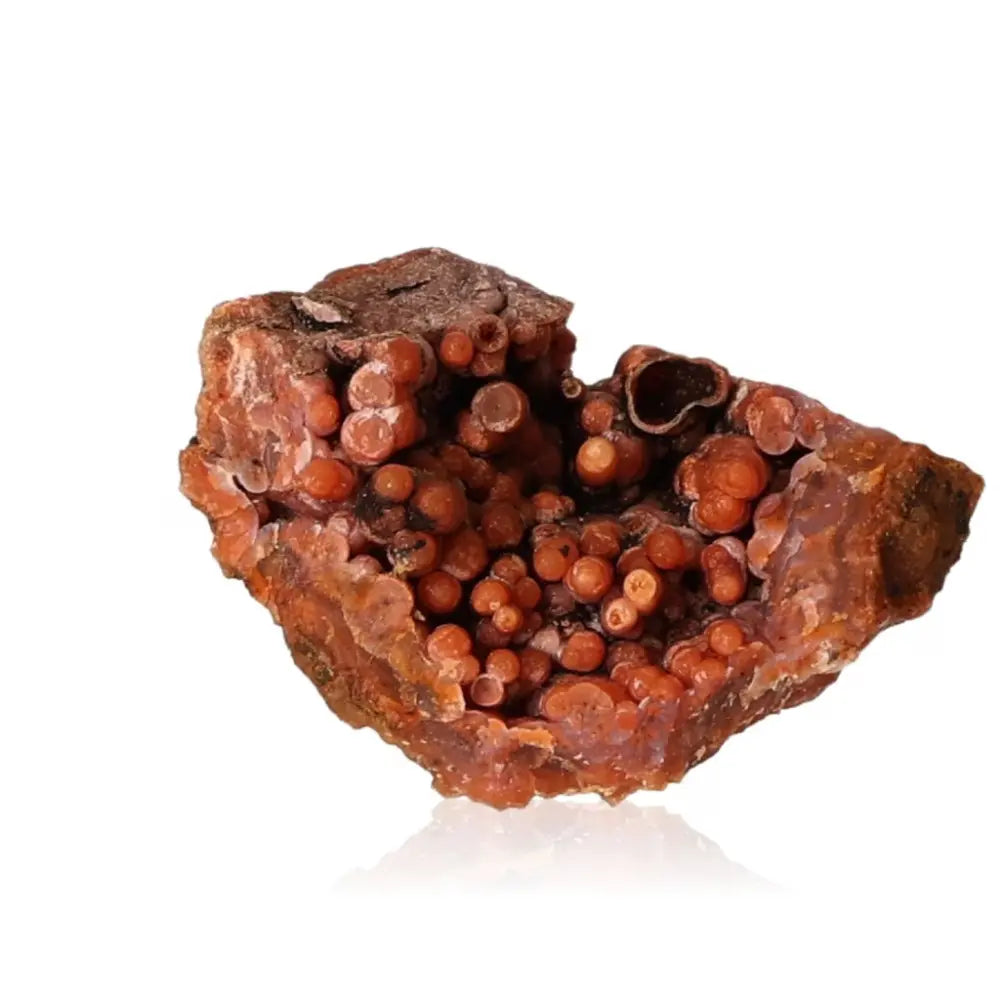 Calcite stalactite gemstone with earthy tones showcasing intricate layers, symbolizing growth and energy, on a white background.