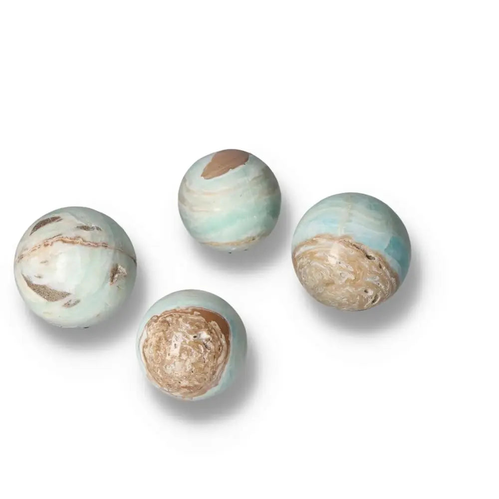 Caribbean Calcite spheres S with ocean blue and white hues, offering a blend of beauty and tranquility from Sylvia Crystals.