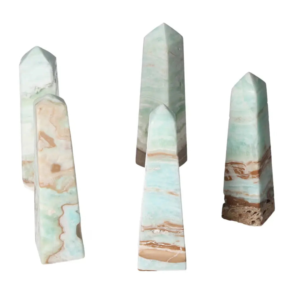 Caribbean Calcite towers showcasing blue and white hues from Sylvia Crystals for emotional balance and spiritual connection.