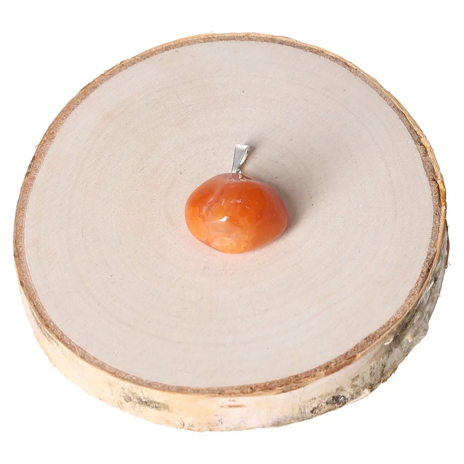 Carnelian Tumbled Pendant with smooth polished finish on wooden slice, symbolizing passion, courage, and creativity in vibrant orange hues.