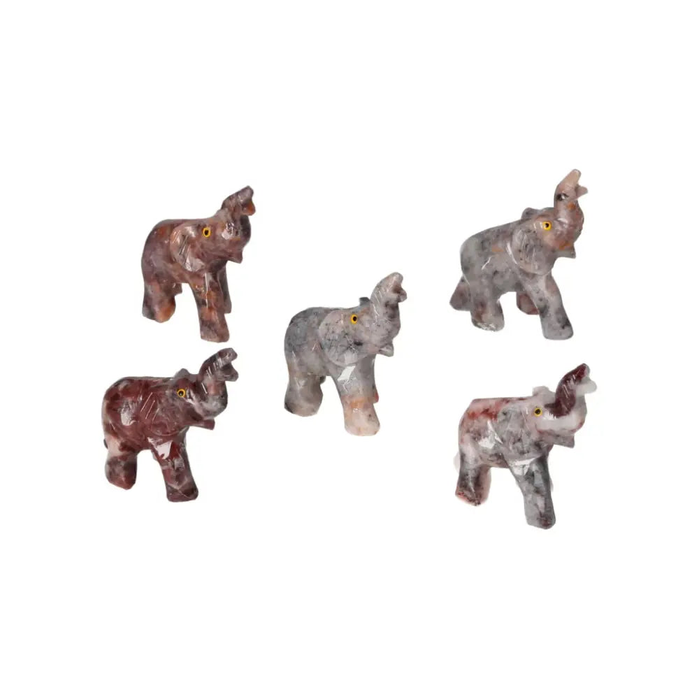 Five carved magnesite crystal elephants displayed, showcasing luxury and spirituality in Sylvia Crystals’ exquisite collection.