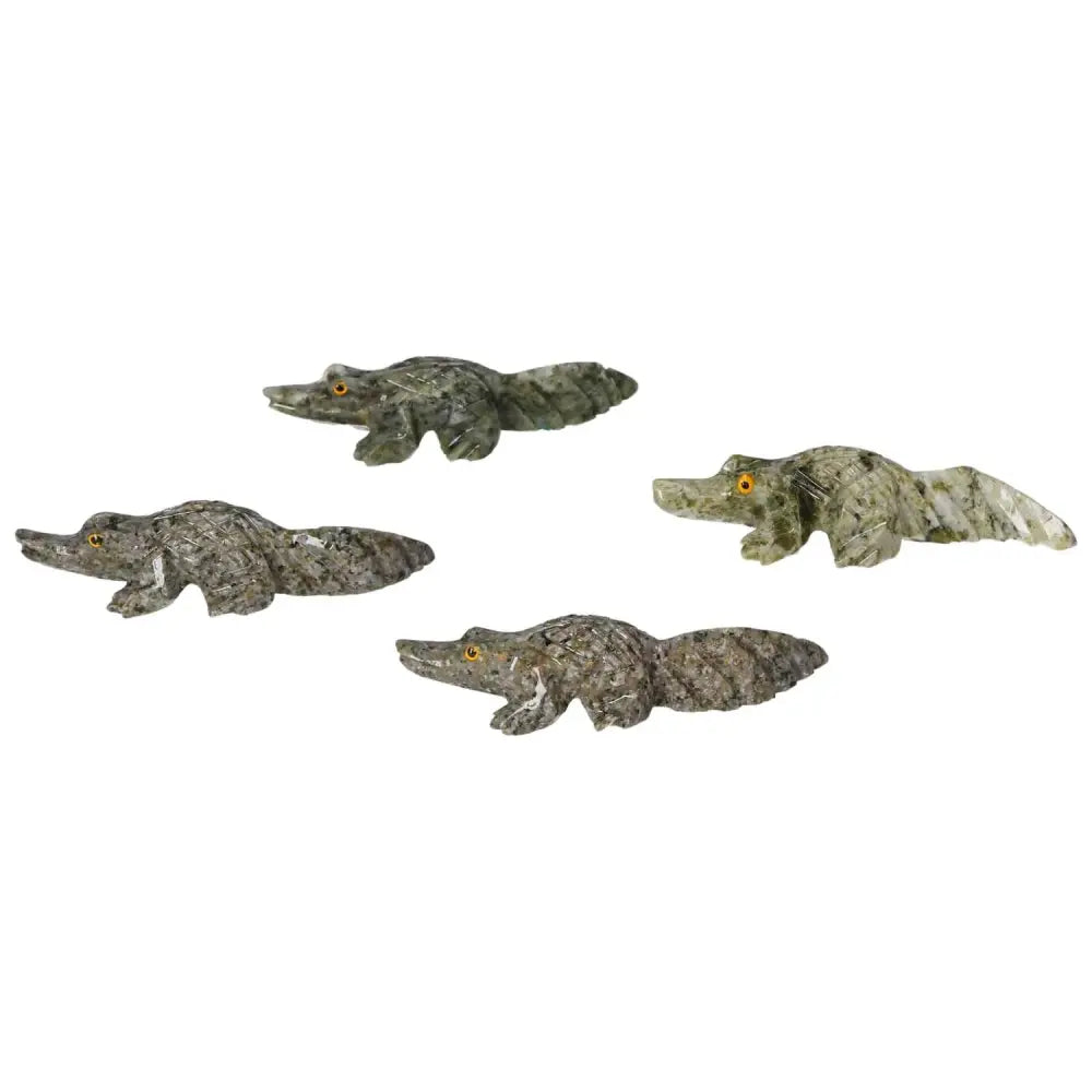 Four intricate carved dolomite alligators, showcasing luxury craftsmanship by Sylvia Crystals, ideal for decorative and mindful living.