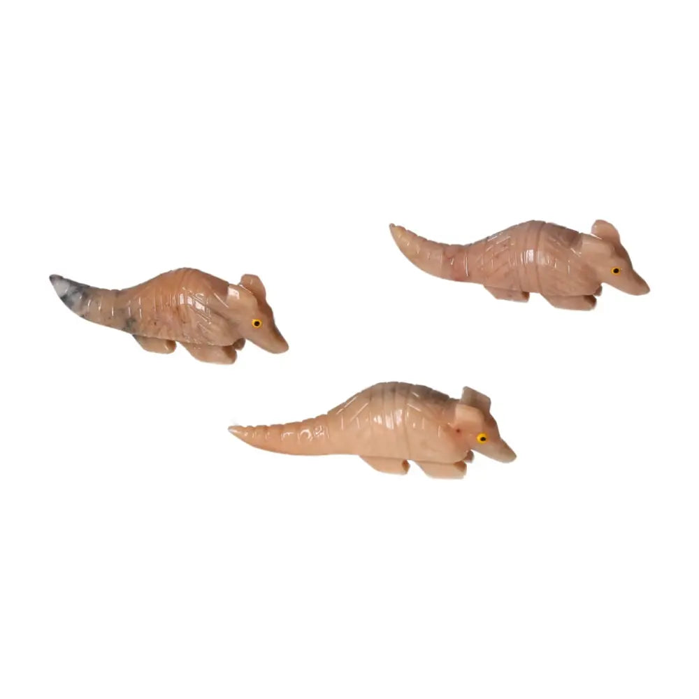 Three carved dolomite armadillos highlighting artistic and spiritual elegance, perfect for emotional healing and ambiance.