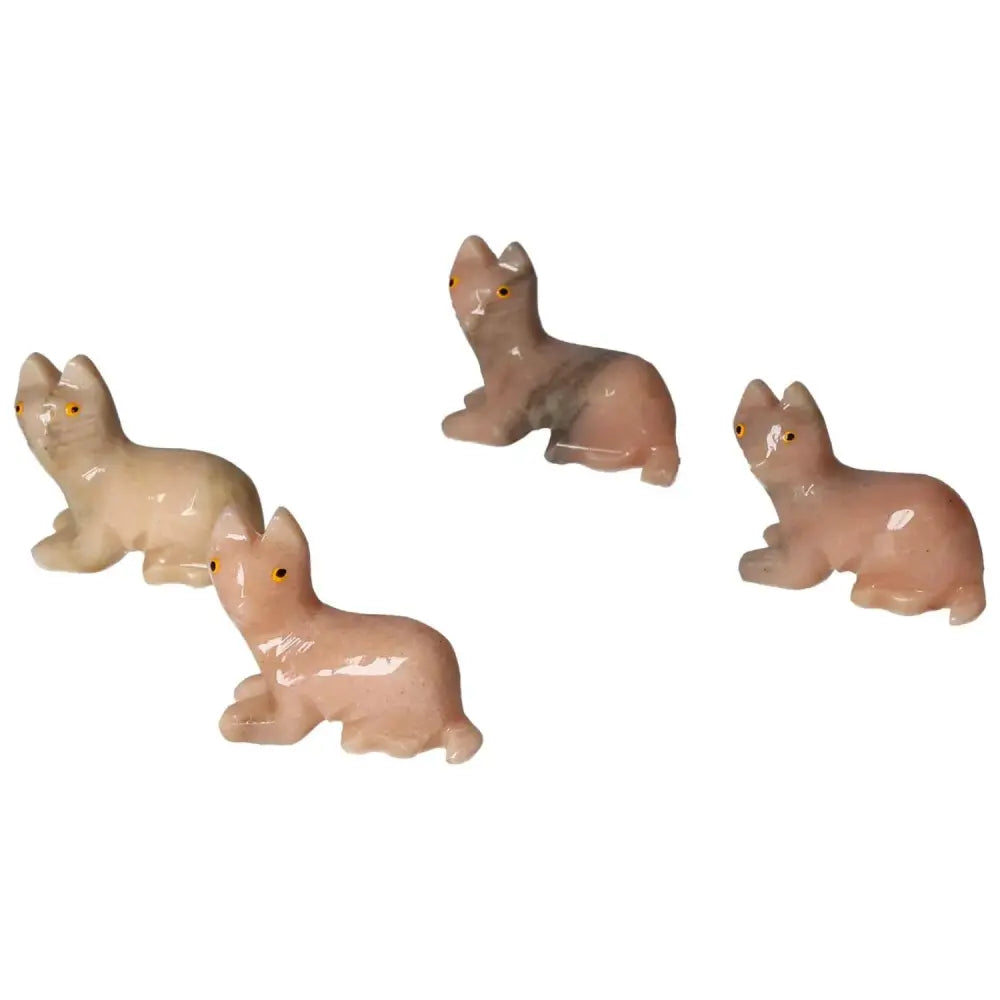 Four carved dolomite cat figurines exude tranquility and elegance, handpicked for luxury and spiritual depth by Sylvia Crystals.