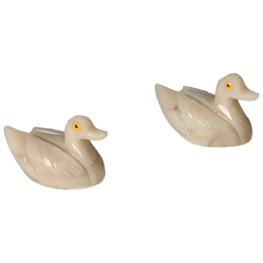Two carved dolomite ducks showcasing artistic craftsmanship by Sylvia Crystals, symbolizing emotional balance and tranquility.