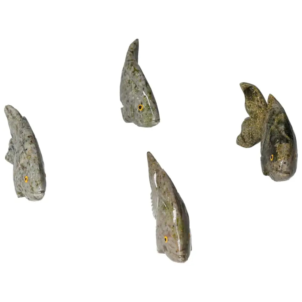 Intricately crafted carved dolomite fish sculptures showcasing unique patterns and grounding properties.