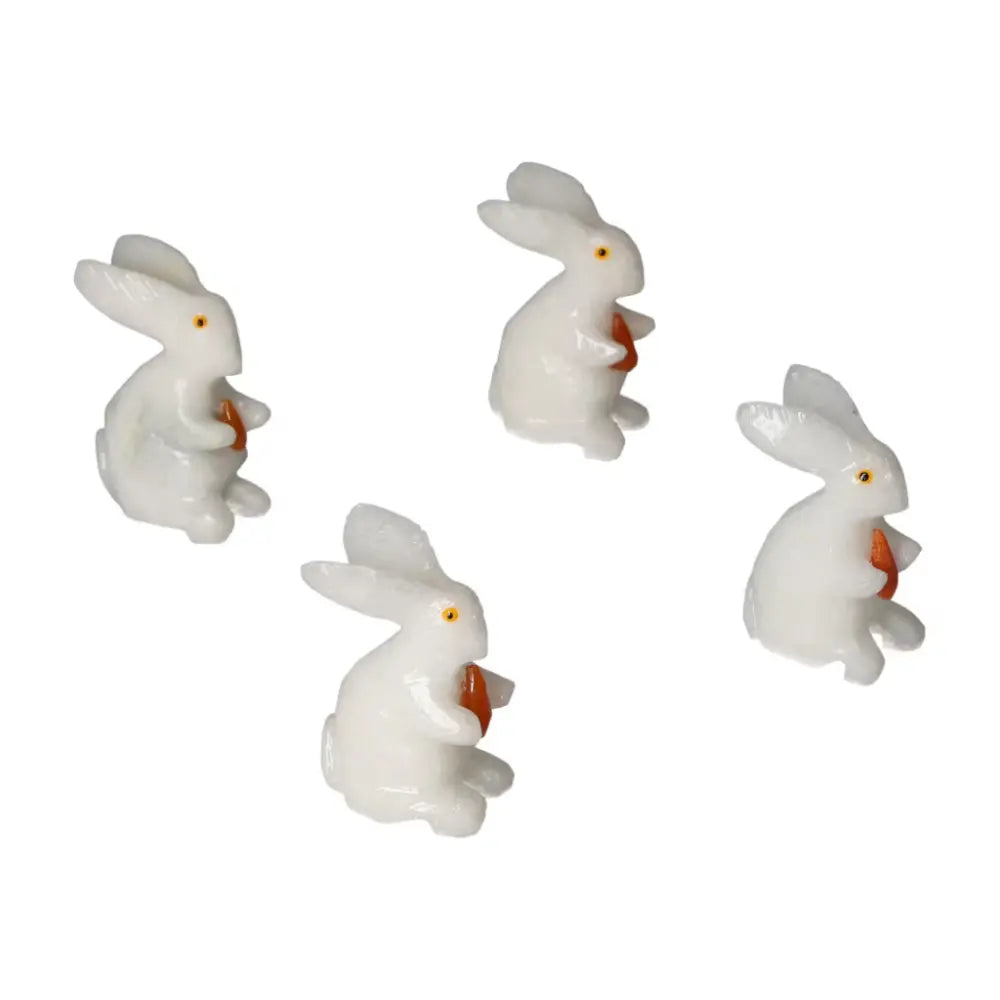 Four elegant carved dolomite rabbit figurines by Sylvia Crystals, symbolizing luxury and emotional well-being, ideal for home decor.