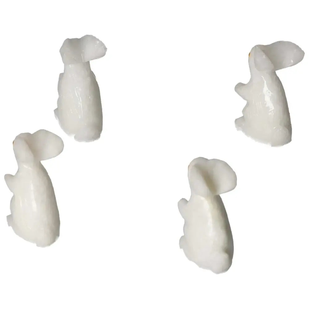 Four carved dolomite rabbit sculptures showcasing serene balance and elegance, perfect for enhancing emotional well-being.
